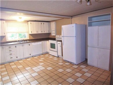 The kitchen is spacious, has ceramic floors, newer