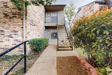 View of exterior entry featuring brick siding