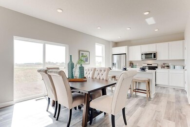 Sun-soaked dining space provides a great space for conversation and good food. Note: Home will include cabinet hardware and tile backsplash. *Photo is of model home. Actual finishes may vary.