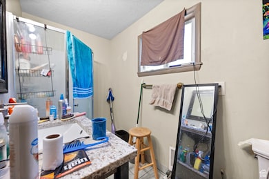 3/4 main floor bathroom with corner shower and granite countertops
