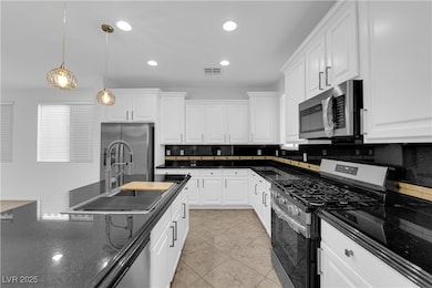 Kitchen with stainless steel appliances, a sink, d