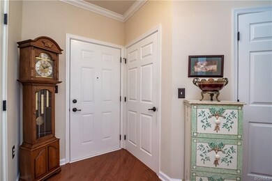 Entrance foyer with wood flooring, crown moulding 