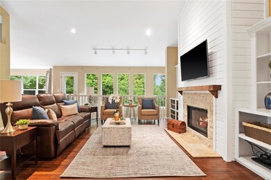 Great room has vaulted ceiling, hardwood flooring,