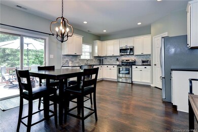 The breakfast area is open to the kitchen and offers access to the deck.