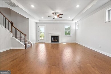 Unfurnished living room featuring a ceiling fan, s