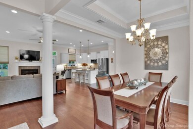 Dining room with crown molding, a fireplace, a rai