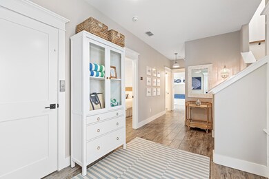 Corridor featuring wood finished floors and baseb
