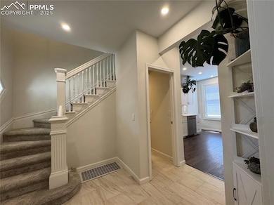 Beautiful foyer with original railing to the stairs