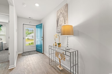 Foyer with baseboards and wood finished floors