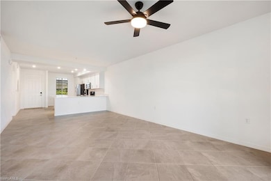 Unfurnished living room with ceiling fan and light