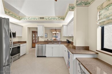 Kitchen with visible vents, a chandelier, a tray c