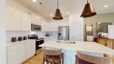 ***This photo was taken from the Grisham model home in Adams Preserve***  The Kitchen Island offers added space for meal preparation and seating for quick meals.