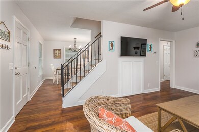 Entryway: stairs to second floor with living and d