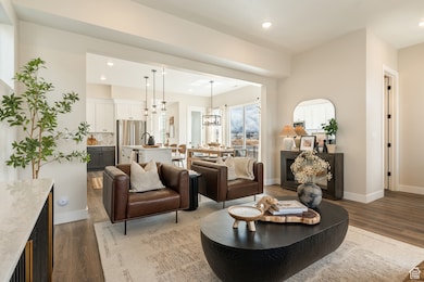Living room with recessed lighting, dark wood-type flooring, and a chandelier