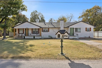 View of front facade with brick siding and a chimney