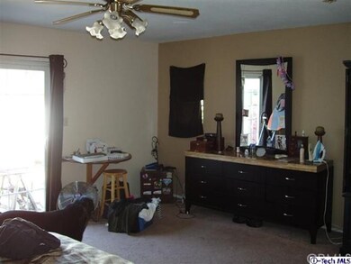 Master bedroom from a different angle showing the light from the sliding french doors.