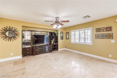 Unfurnished living room with ceiling fan and baseb
