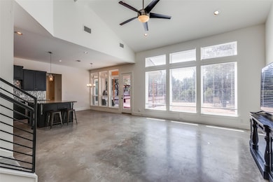 Living area featuring visible vents, ceiling fan,