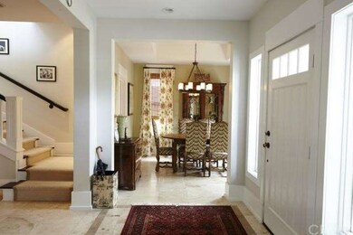 Entry foyer with travertine flooring.  Formal dini