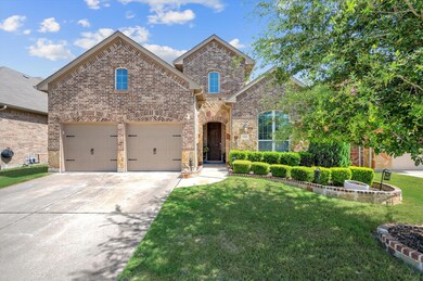 Front facade with a garage and a front lawn