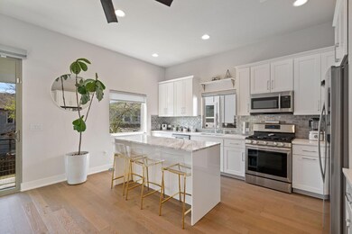 Kitchen with light wood-style floors, stainless s