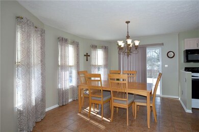 Dining area has tons of natural light, slider to t