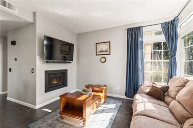 The living room is light and bright with large windows facing west and south.  These windows are fitted with motorized window blinds controlled by a remote (you can see it on the base of the lamp on the left). Very convenient.