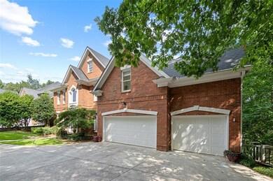 View of home's exterior with concrete driveway, brick siding, and a 3 car garage