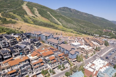Aerial view of property and surrounding area with mountains