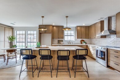 Kitchen with a kitchen island, wall chimney range 