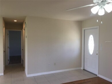 Living room looking to hallway and front door.