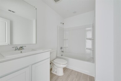 Full bathroom featuring vanity, toilet, hardwood /
