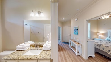 Interior space featuring vanity, crown molding, ce
