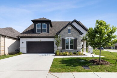 View of front of house with a garage and a front y