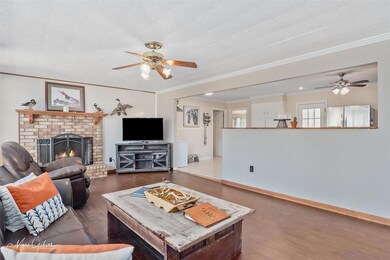 Living area with a brick fireplace, crown molding,
