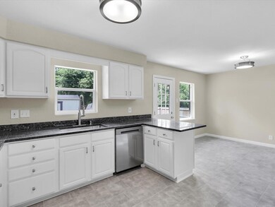 Kitchen featuring white cabinets, kitchen peninsul