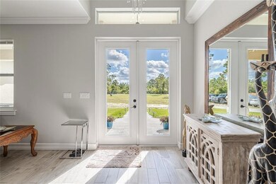 Modern home with high end features. Crown molding, wood plank ceramic tiles, and crystal studded light fixtures lend to the grand feel of this home.
