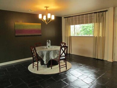 Dining Room. Natural slate flooring throughout hom