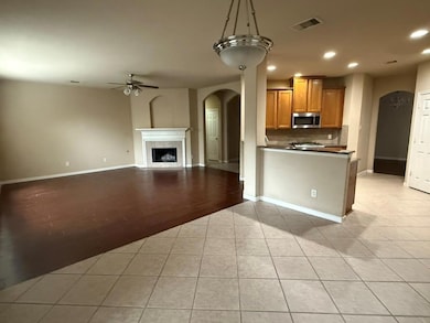 Kitchen featuring arched walkways, stainless stee