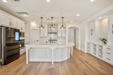 The kitchen boasts a deco wood paneled island with