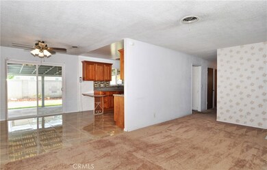 Newer floors in the dining lead out through dual pane slider to the backyard
