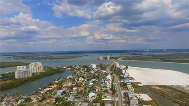 View of Southern Tip of Fort Myers Beach with Marina Towers just steps away from its white sandy shores.