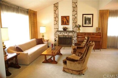 Spacious formal living room off entry with cozy fireplace. 