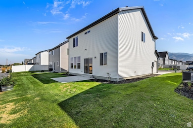 Back of property featuring a patio area, a mountain view, and a residential view