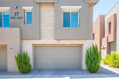 View of front of home with a garage, stucco siding