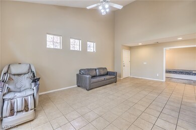 Living area with high vaulted ceiling, baseboards,