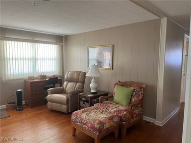 Sitting room featuring baseboards, wood-type floor