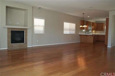 The great room has nice hardwood floors, gas firep