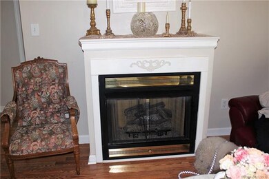Warm your toes with the cozy Gas Log Fireplace.