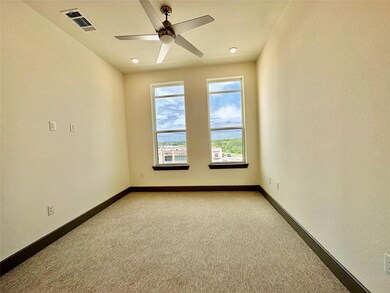 Carpeted empty room with ceiling fan